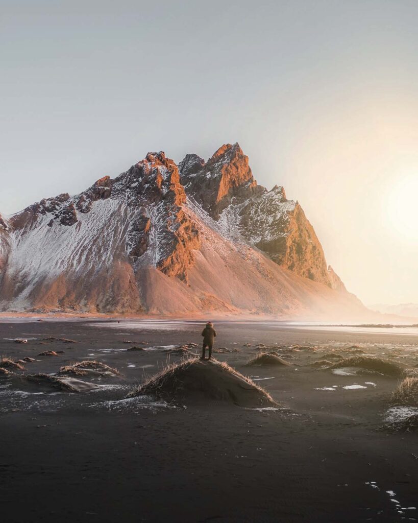 person standing on a hill with a stunning mountain W8ZBL2F